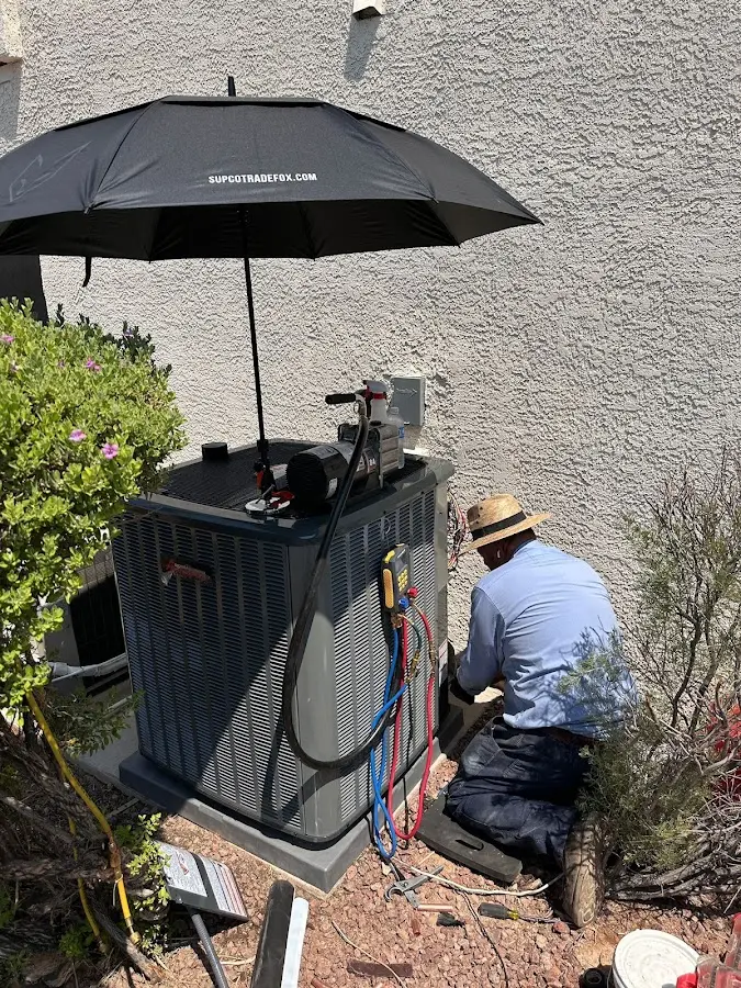 HVAC technician performing outdoor AC maintenance in Port Townsend